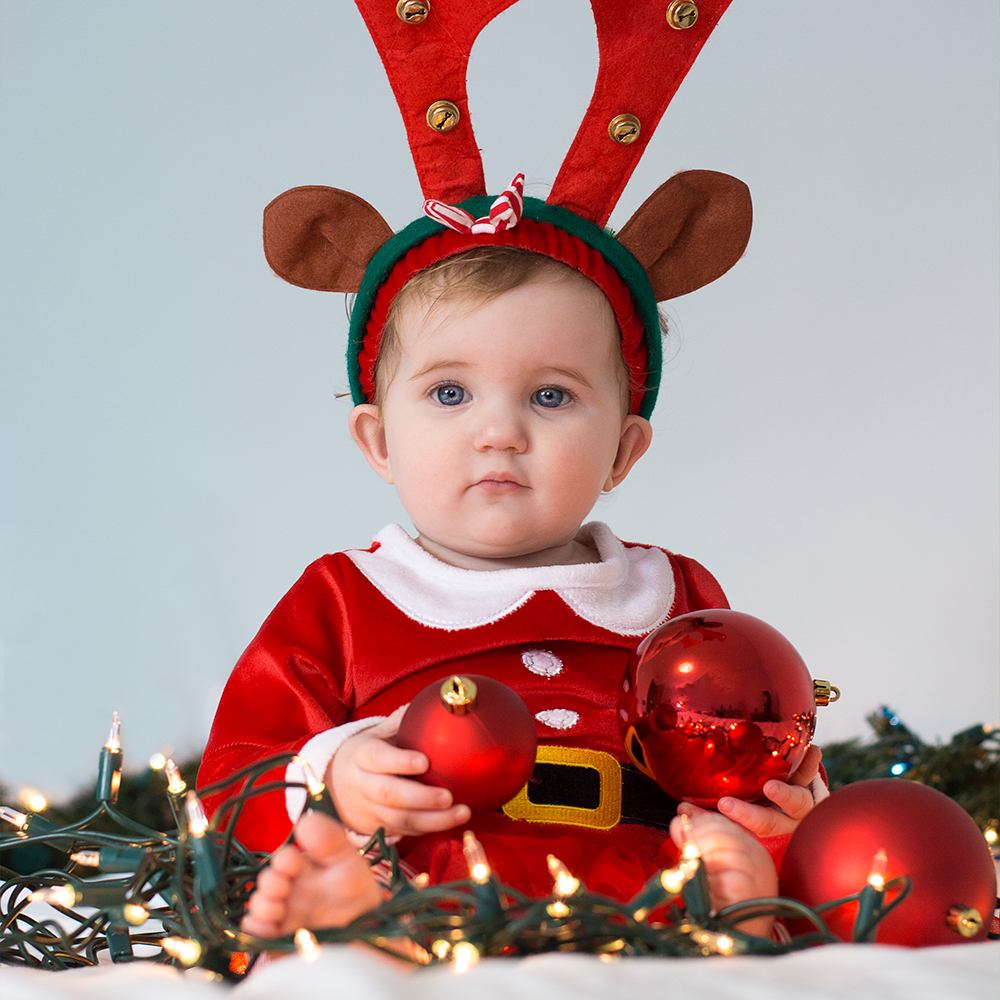 Photo of baby in Christmas outfit by Jessika Digital
